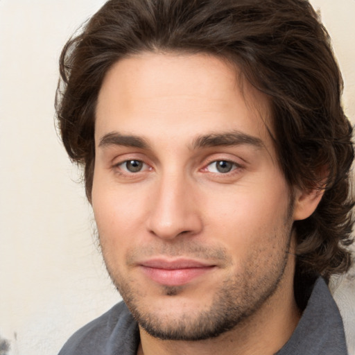 Joyful white young-adult male with medium  brown hair and brown eyes