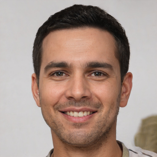 Joyful white young-adult male with short  brown hair and brown eyes