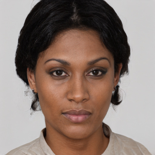 Joyful latino young-adult female with short  black hair and brown eyes