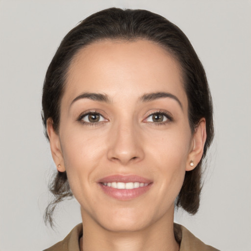 Joyful white young-adult female with medium  brown hair and brown eyes