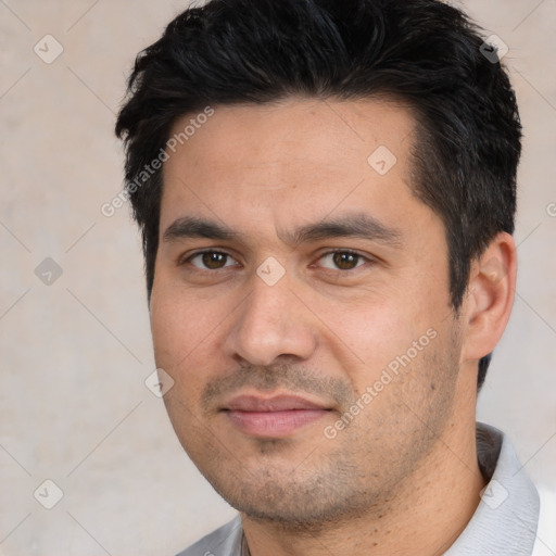 Joyful white young-adult male with short  black hair and brown eyes