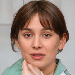 Joyful white young-adult female with medium  brown hair and blue eyes