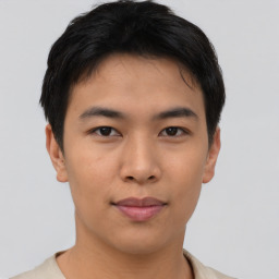 Joyful asian young-adult male with short  black hair and brown eyes