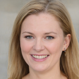 Joyful white young-adult female with medium  brown hair and blue eyes