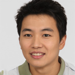 Joyful asian young-adult male with short  brown hair and brown eyes