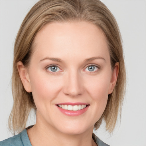 Joyful white young-adult female with medium  brown hair and blue eyes