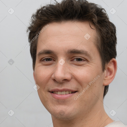 Joyful white adult male with short  brown hair and brown eyes