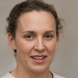 Joyful white adult female with short  brown hair and grey eyes