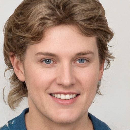 Joyful white young-adult female with medium  brown hair and blue eyes