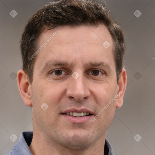 Joyful white adult male with short  brown hair and grey eyes