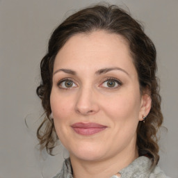 Joyful white adult female with medium  brown hair and brown eyes