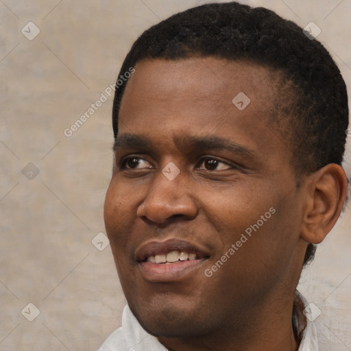 Joyful black young-adult male with short  black hair and brown eyes