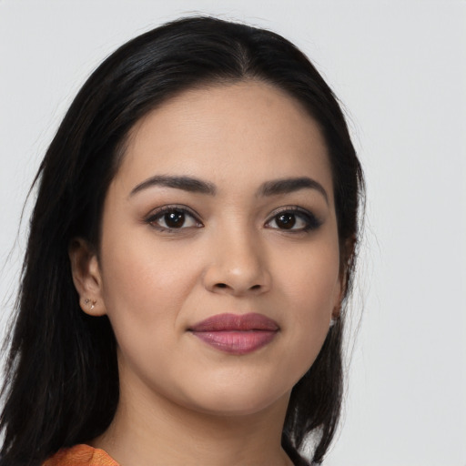 Joyful latino young-adult female with long  black hair and brown eyes