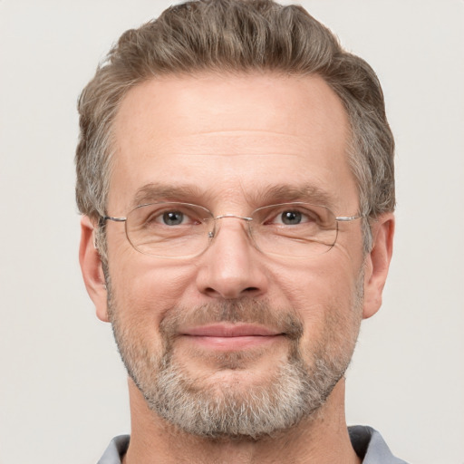 Joyful white middle-aged male with short  brown hair and grey eyes