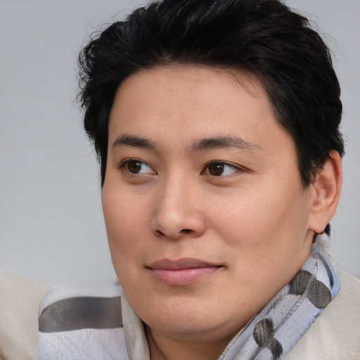 Joyful asian young-adult female with short  brown hair and brown eyes