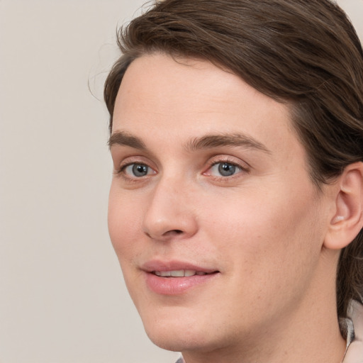 Joyful white young-adult female with medium  brown hair and grey eyes