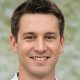 Joyful white young-adult male with short  brown hair and brown eyes