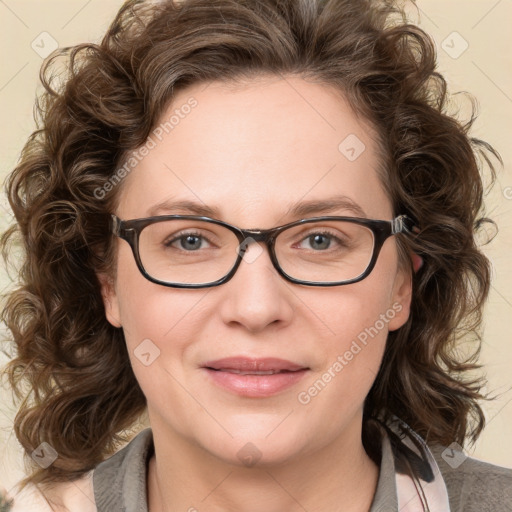 Joyful white adult female with medium  brown hair and blue eyes