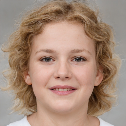 Joyful white child female with medium  brown hair and blue eyes