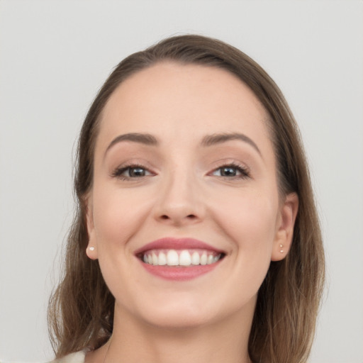 Joyful white young-adult female with long  brown hair and grey eyes