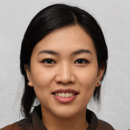 Joyful asian young-adult female with medium  black hair and brown eyes
