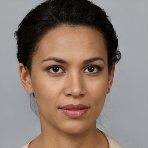 Joyful latino young-adult female with short  brown hair and brown eyes