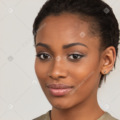 Joyful black young-adult female with short  brown hair and brown eyes