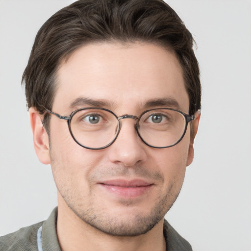 Joyful white adult male with short  brown hair and grey eyes