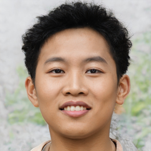 Joyful asian young-adult male with short  brown hair and brown eyes