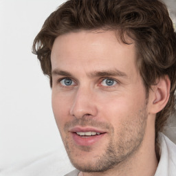 Joyful white adult male with short  brown hair and grey eyes