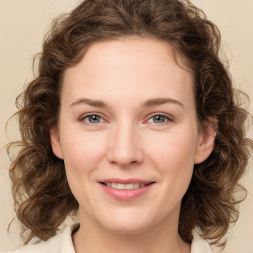 Joyful white young-adult female with medium  brown hair and green eyes