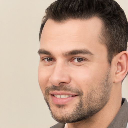 Joyful white young-adult male with short  brown hair and brown eyes