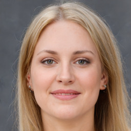 Joyful white young-adult female with long  brown hair and blue eyes