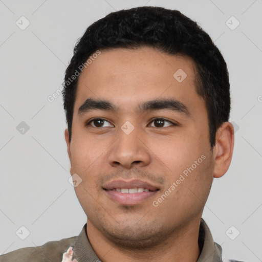 Joyful latino young-adult male with short  black hair and brown eyes