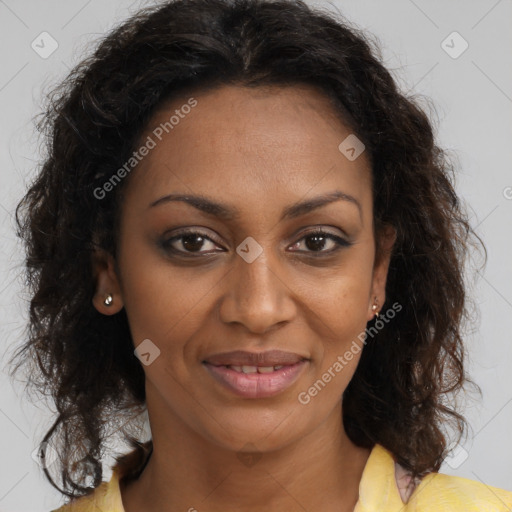 Joyful black adult female with long  brown hair and brown eyes