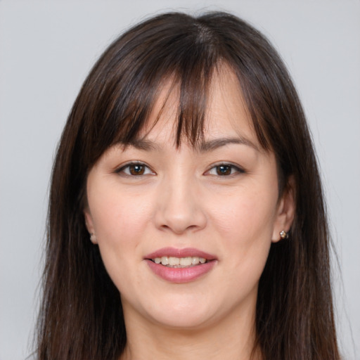 Joyful white young-adult female with long  brown hair and brown eyes