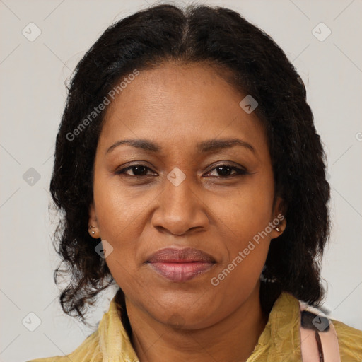 Joyful black adult female with medium  brown hair and brown eyes