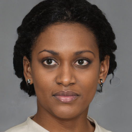 Joyful black young-adult female with short  brown hair and brown eyes
