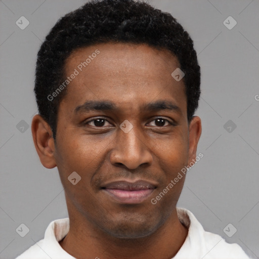 Joyful black young-adult male with short  black hair and brown eyes