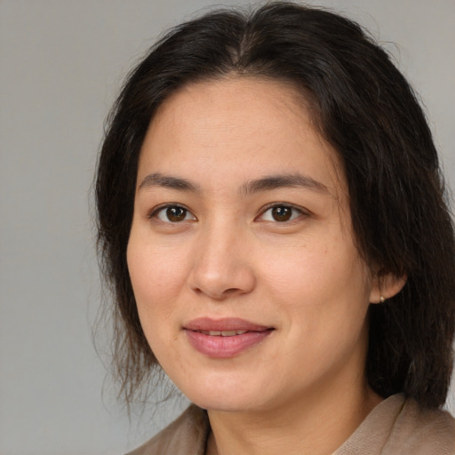 Joyful white adult female with medium  brown hair and brown eyes