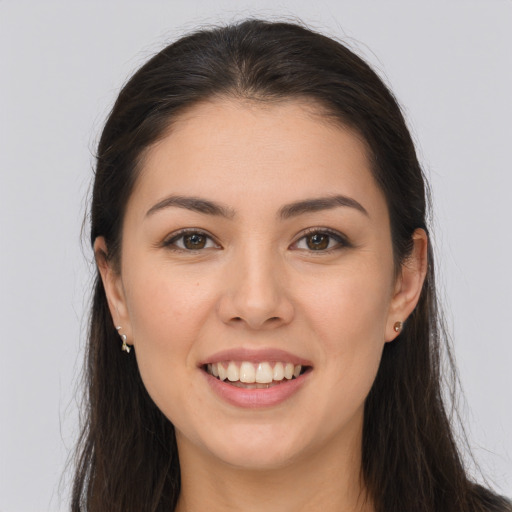 Joyful white young-adult female with long  brown hair and brown eyes