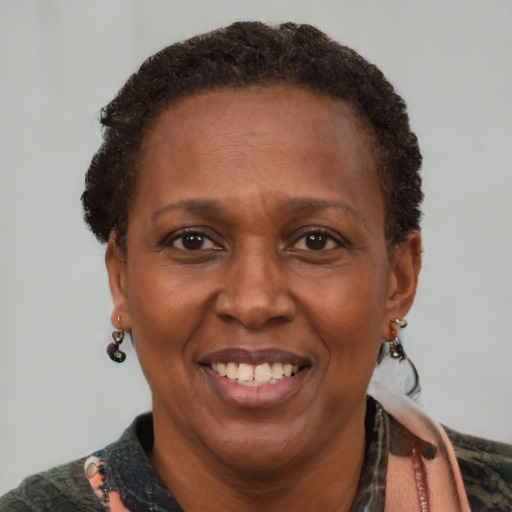 Joyful black adult female with short  brown hair and brown eyes