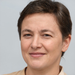 Joyful white adult female with short  brown hair and brown eyes