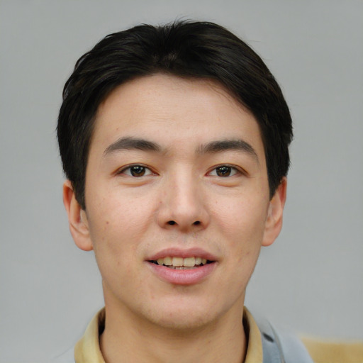 Joyful asian young-adult male with short  brown hair and brown eyes