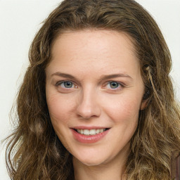 Joyful white young-adult female with long  brown hair and green eyes