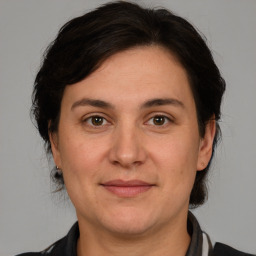 Joyful white adult female with medium  brown hair and brown eyes