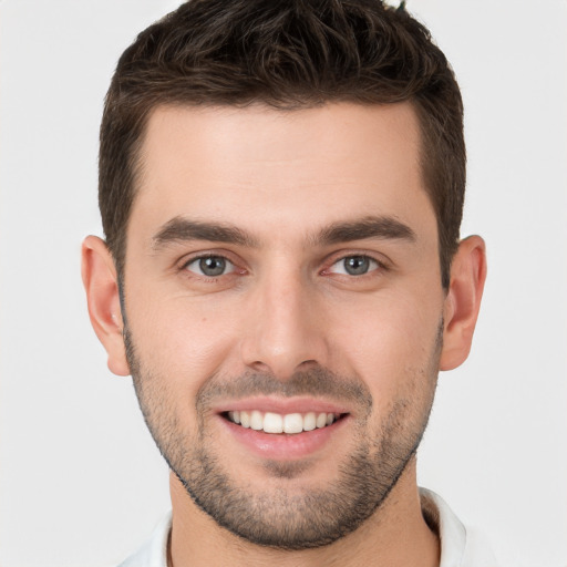 Joyful white young-adult male with short  brown hair and brown eyes