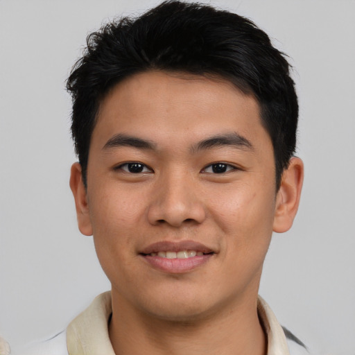 Joyful asian young-adult male with short  brown hair and brown eyes