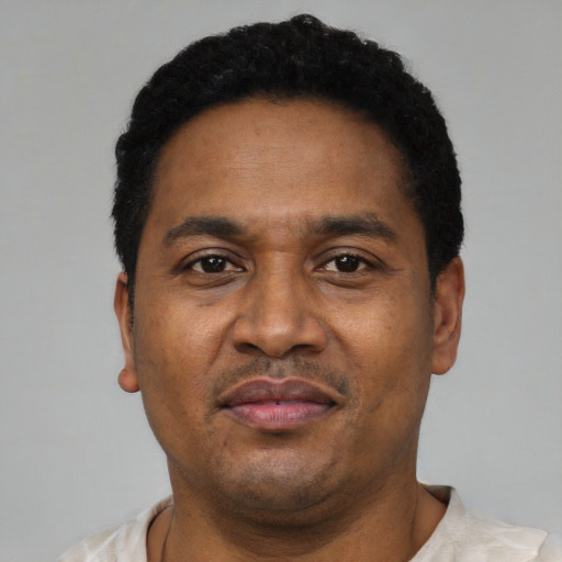 Neutral latino adult male with short  black hair and brown eyes