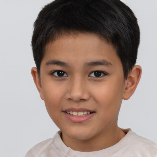 Joyful asian child male with short  brown hair and brown eyes